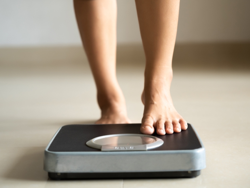 a woman stepping on a scale