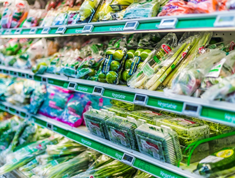 Produce in plastic packaging on on grocery store shelves