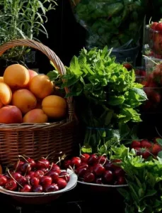 Fresh apricots, peaches, cherries and strawberries for sale at a farmer's market in May