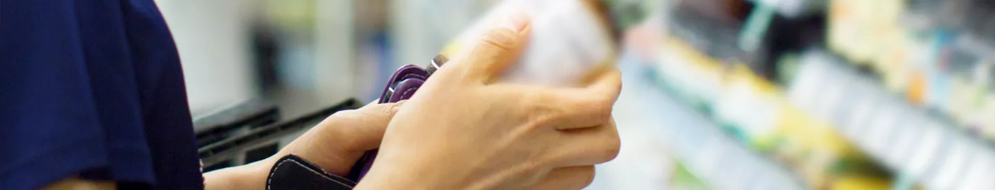 woman looking at vitamin bottle