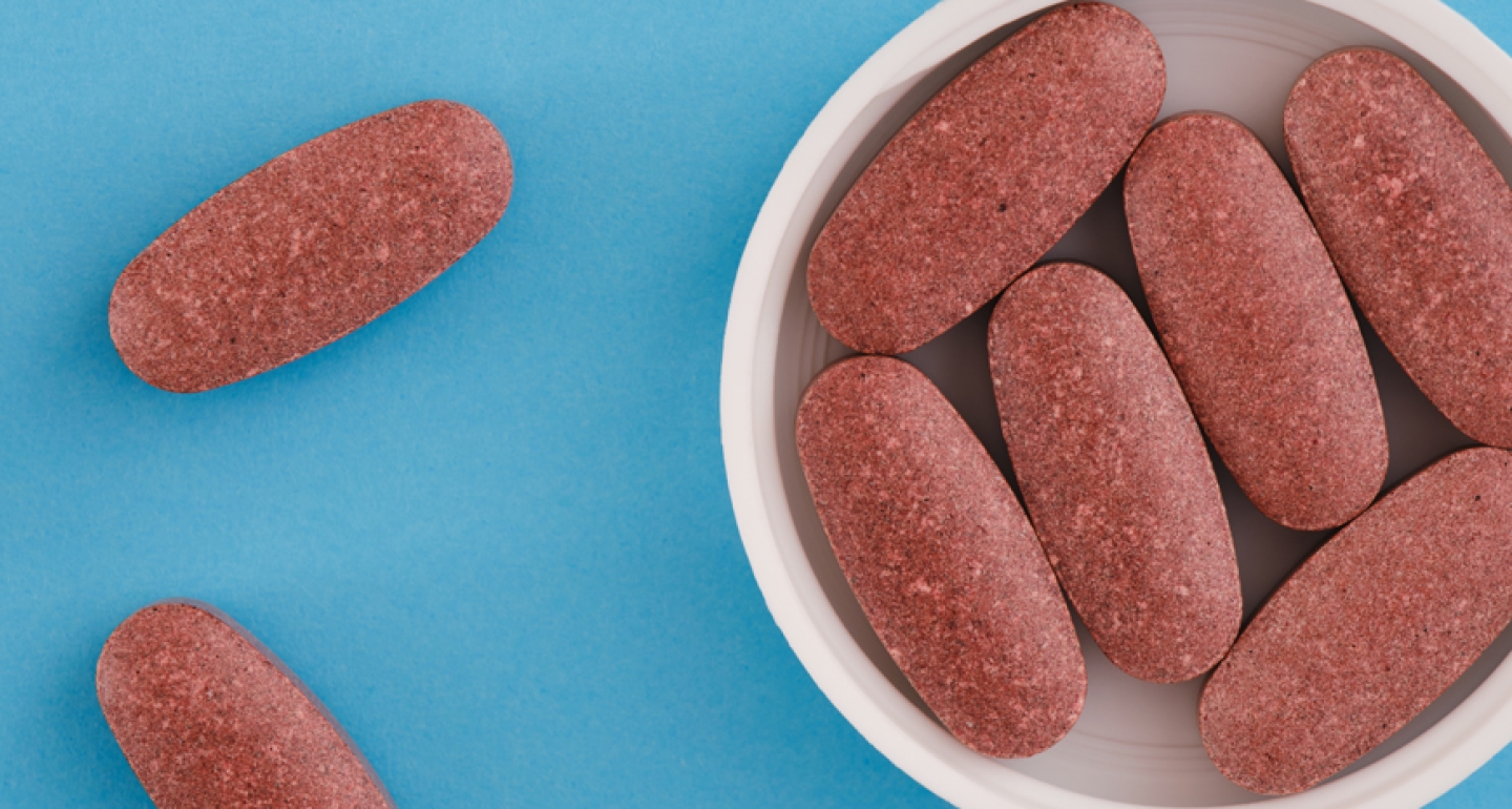 Red yeast rice tablets on a blue background