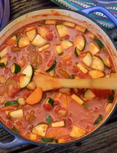 over head shot of large pot filled with minsestrone stew