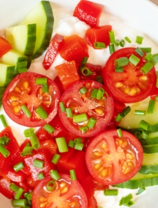 bowl filled with tomatoes, cucumbers and cottage cheese