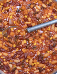 large pot with multi bean chili and a large silver spoon