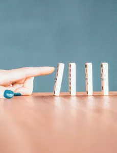 Person pushing dominos