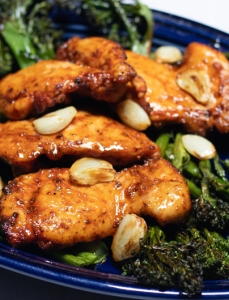 dark blue plate with broccolini and chicken