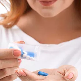 woman holding pill bottle