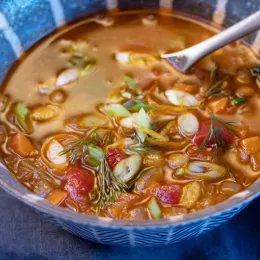 a bowl of greek lentil soup