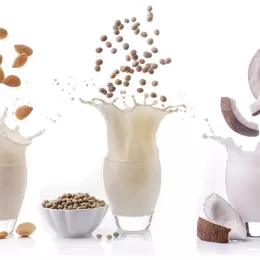 various milks splashing in cup