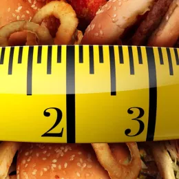 tape measure stretched across junk food