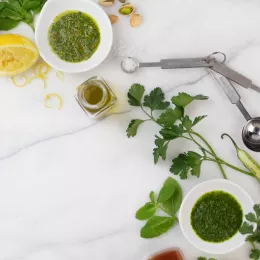 herb sauces with ingredients on marble slab