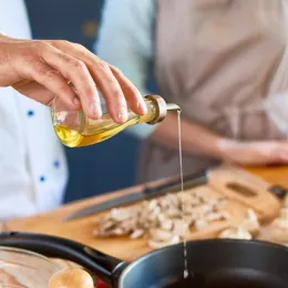 pouring oil into a skillet