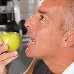 man biting into apple