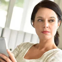 woman holding a tablet screen