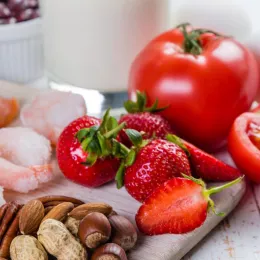 array of foods including tomato, berries, nuts, and shrimp