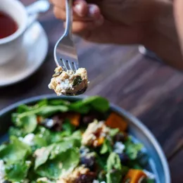 fork over a plate of salad