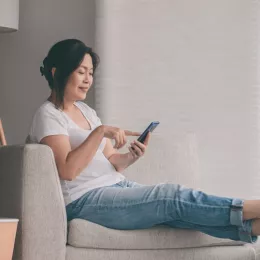 a woman sitting and using her cellphone