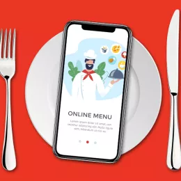 table setting with smartphone showing an online ordering app