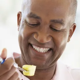 man eating pineapple