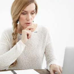 woman looking at computer screen