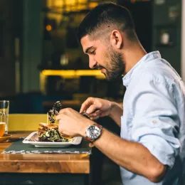 young man sitting and eating a meal