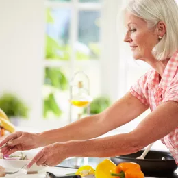 older woman prepping food in a kitchen