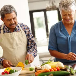 a man and a woman chopping vegetables