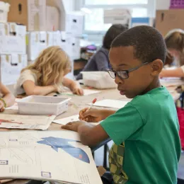 A group of young students focusing on their work.