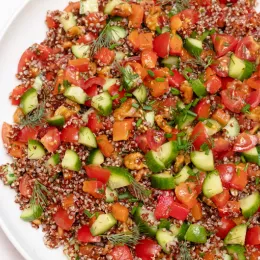 bowl of quinoa, with other chopped vegetables and herbs