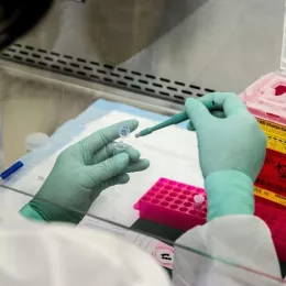 CDC scientist prepares biopsy sample for molecular testing in laboratory