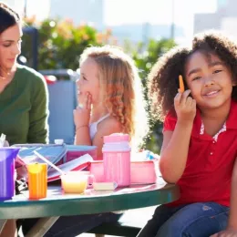 Children eating healthy snacks and lunch at school