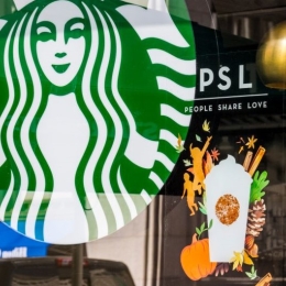 A Starbucks storefront advertising the annual Pumpkin Spice Latte