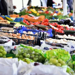 Green grapes and other produce on display at an outdoor market