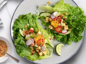 a plate of peanut lettuce wraps