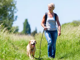 a woman walking her dog