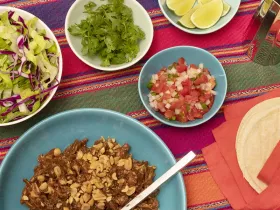 chicken mole with lettuce, cilantro, pico de gallo, and lime wedges