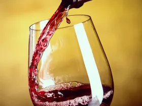 red wine pouring into a glass