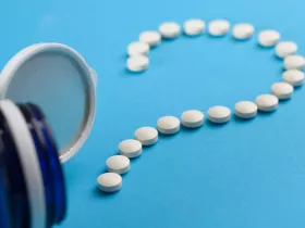 supplement pills in the shape of a question mark