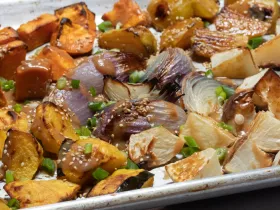 chopped winter vegetables sprinkled with sesame seeds and scallions roasted on baking sheet