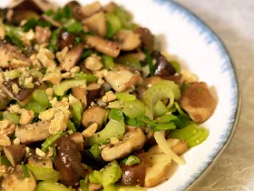 half a plate of crunchy mushroom salad on a white plate