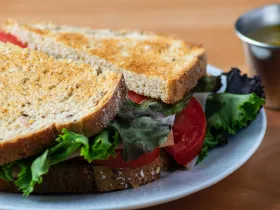 A sliced chicken and vegetable sandwich served at a restaurant