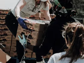 Food service workers unload crates of food