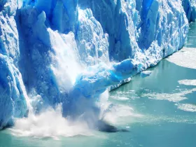 a glacier melting into a lake