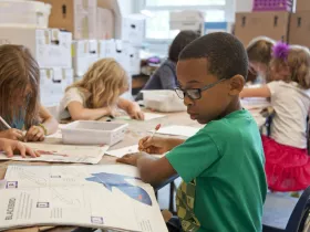 A group of young students focusing on their work.