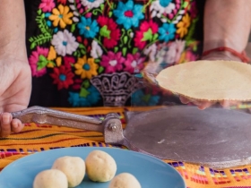 Tortilla press, testales (maize dough) and resulting tortillas. Process of making corn tortillas