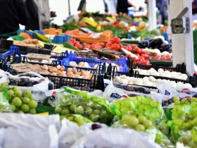 Green grapes and other produce on display at an outdoor market