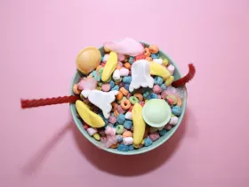 A bowl of colorful cereal, candies, and multi-colored marshmallows 