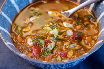 a bowl of greek lentil soup