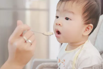 Baby being fed baby food