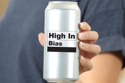 a woman holding a can of soda with a "high in bias" label on it